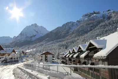 a ski resort with snow covered buildings and mountains at Cèsa Civetta in Canazei