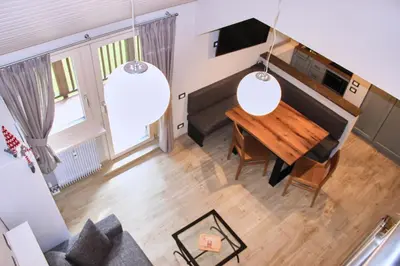 an overhead view of a living room with a wooden table at Cèsa Civetta in Canazei