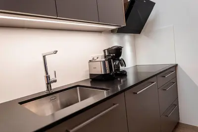 a kitchen with a sink and a coffee maker at Ölackererhof in Bressanone