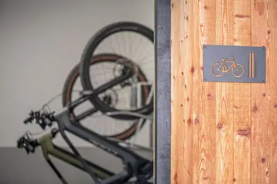 a bike rack with a sign on the side of it at Ölackererhof in Bressanone