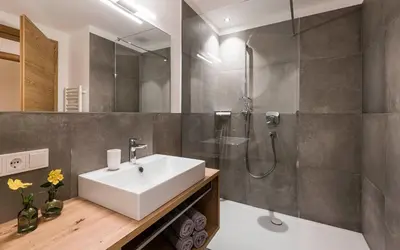 a bathroom with a sink and a shower at Ölackererhof in Bressanone