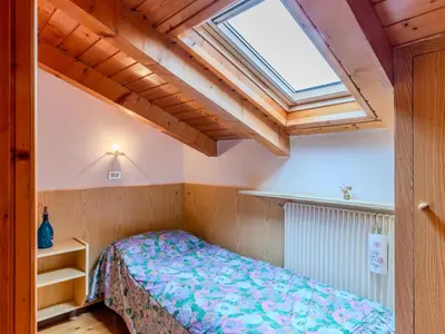 a bedroom with a bed and a skylight at Apartment Ermeti by Interhome in Sfruz