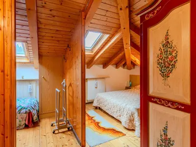 a bedroom with a bed in a wooden house at Apartment Ermeti by Interhome in Sfruz
