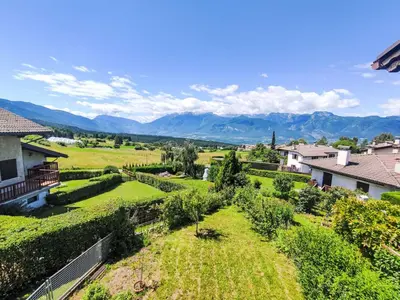 a village covered in snow with mountains in the background at Apartment Ermeti by Interhome in Sfruz