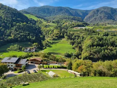 an aerial view of a farm with mountains in the background at Ferienwohnungen Koflerhof in Castelrotto