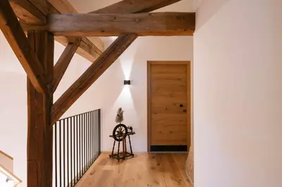 a room with wooden beams and a door at Schulmeisterhof in Kastelruth