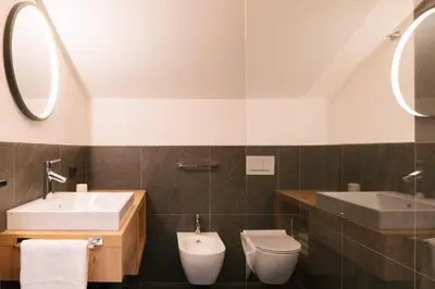 a bathroom with a sink and a toilet at Schulmeisterhof in Kastelruth