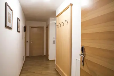 a hallway with a wooden door in a room at Ciasa Vilin in Corvara in Badia