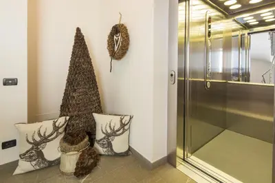 a christmas tree and two pillows in a hallway at Ciasa Vilin in Corvara in Badia