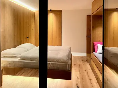 a bedroom with a bed and a mirror at Egger 5 in Sorafurcia