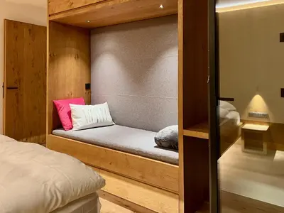 a small bedroom with a bed and a wall at Egger 5 in Sorafurcia