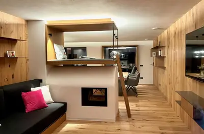a living room with a loft bed and a fireplace at Egger 5 in Sorafurcia