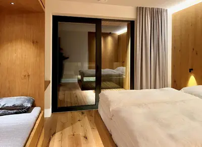 a bedroom with two beds and a mirror at Egger 5 in Sorafurcia