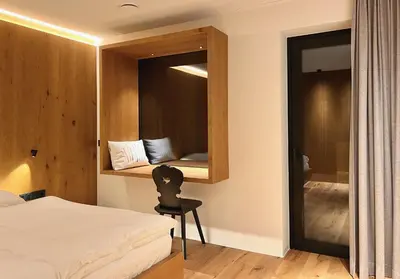 a bedroom with a bed and a chair in a room at Egger 5 in Sorafurcia