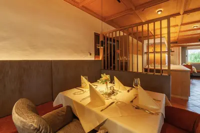 a dining room with a white table and chairs at Pension Stern in Aldino
