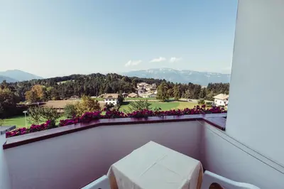 a balcony with a table and a view of a mountain at Pension Stern in Aldino
