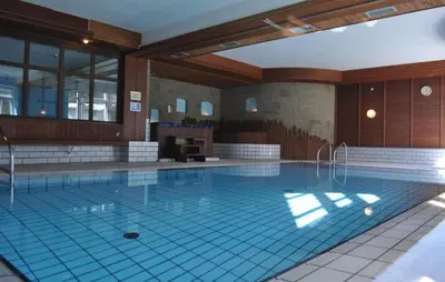 a large swimming pool in a building at Appartaments Lavaredo in Carbonin