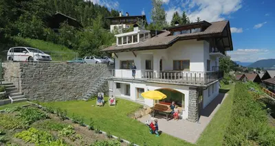 a group of people standing outside of a house at Ferienwohnungen Waldruhe in Santa Valburga St. Walburg