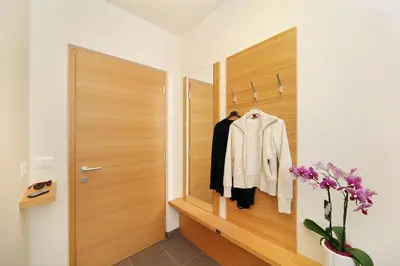 a hallway with a closet with a coat rack at Ferienwohnungen Waldruhe in Santa Valburga St. Walburg