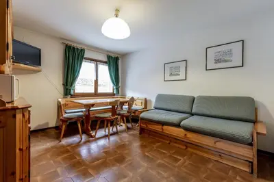 a living room with a couch and a table at Stella Alpina in Campitello di Fassa