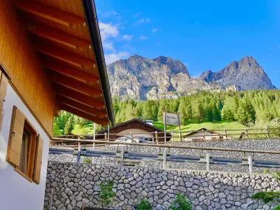 a building with a view of some mountains at Climb house Geremia in Selva di Cadore