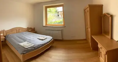 a bedroom with a bed and a window at Climb house Geremia in Selva di Cadore