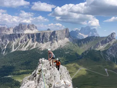 two people standing on the top of a mountain at Climb house Geremia in Selva di Cadore