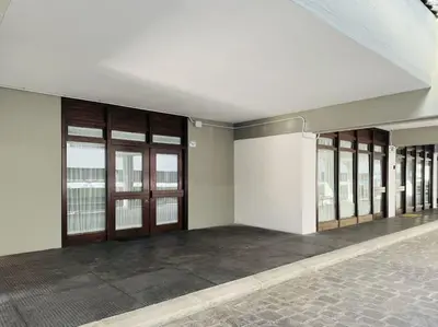 an empty room with doors and windows in a building at Appartamento nel cuore della Val di Fassa in Campestrin