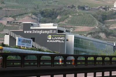 a building with a sign on the side of it at Die Bücherstube im living Kampill in Bolzano
