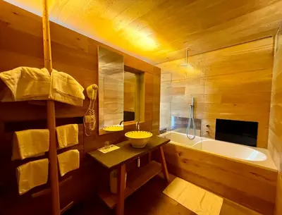 a bathroom with a tub and a sink and a bath tub at Die Bücherstube im living Kampill in Bolzano