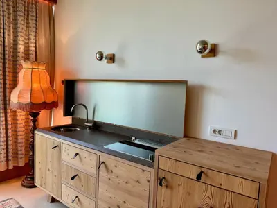 a bathroom with a sink and a mirror on the wall at Die Bücherstube im living Kampill in Bolzano