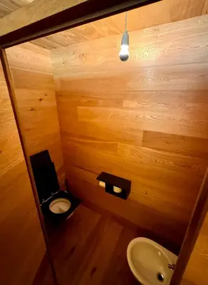 a bathroom with a toilet and a sink at Die Bücherstube im living Kampill in Bolzano