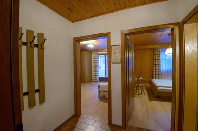 a hallway with a room with a bed and a mirror at Appartement Alpenblick in Valdaora