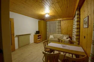 a living room with a table and a couch at Appartement Alpenblick in Valdaora