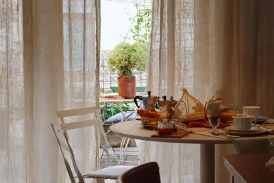 a table with food on it next to a window at Casa Fellin 1891 B&B in Cles