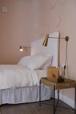 a bedroom with a bed and a table with a lamp at Casa Fellin 1891 B&B in Cles