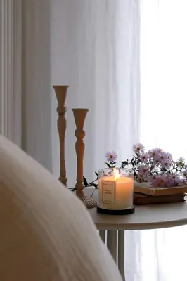 a candle sitting on a table next to a bed at Casa Fellin 1891 B&B in Cles