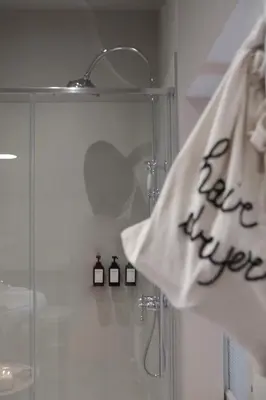 a shower with a towel with the words take over on it at Casa Fellin 1891 B&B in Cles