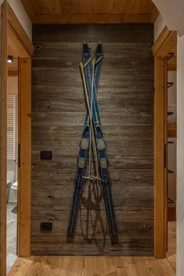 a group of skis hanging on a wall at Casa dell Alpinista a Cortina d Ampezzo in Cortina dʼAmpezzo