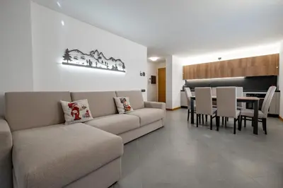 a living room with a couch and a table at Alba Chiara 39 in Alba di Canazei