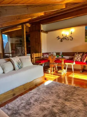 a living room with a couch and a table at Chalet vicino le piste da sci in Pocol