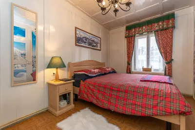 a small bedroom with a bed and a window at Casa del Batesta in Moena
