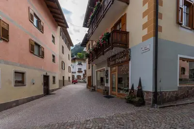 an empty street in a town with buildings at Casa del Batesta in Moena