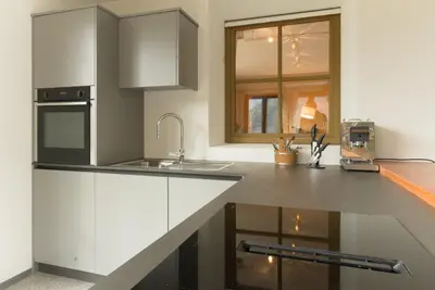 a kitchen with white cabinets and a sink at Puent Seceda-Dolomiti-Val Gardena in Ortisei