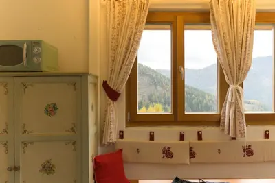 a room with two windows with a view of mountains at Puent Seceda-Dolomiti-Val Gardena in Ortisei