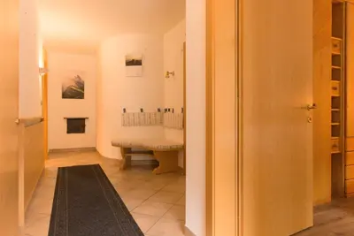 a hallway with a sink and a bench in a room at Puent Seceda-Dolomiti-Val Gardena in Ortisei