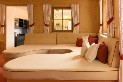 a living room with two beds and a couch at Puent Seceda-Dolomiti-Val Gardena in Ortisei