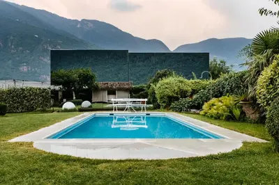 a swimming pool in the yard of a house at Mirror Houses in Bolzano