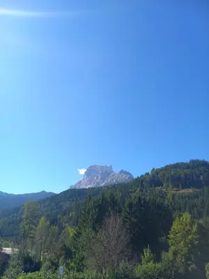 a mountain in the distance with a blue sky at Mansarda Vale e Schena con vasca idromassaggio 4 posti letto a Cortina d'Ampezzo in San Vito di Cadore