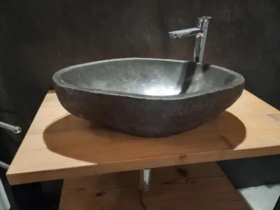 a bowl sink on a wooden counter in a bathroom at Mansarda Vale e Schena con vasca idromassaggio 4 posti letto a Cortina d'Ampezzo in San Vito di Cadore